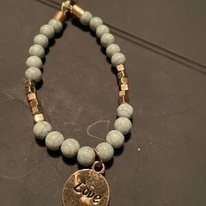 Gold tone Charm Bracelet with LOVE charm.